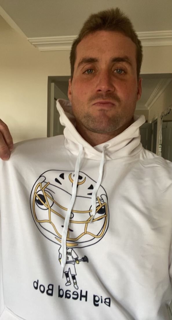 A man wearing the white Big Head Bob hoodie
