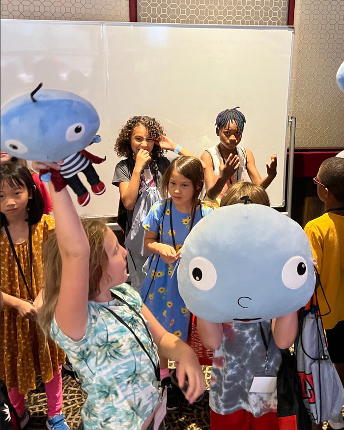 Kids holding Big Head Bob plush heads