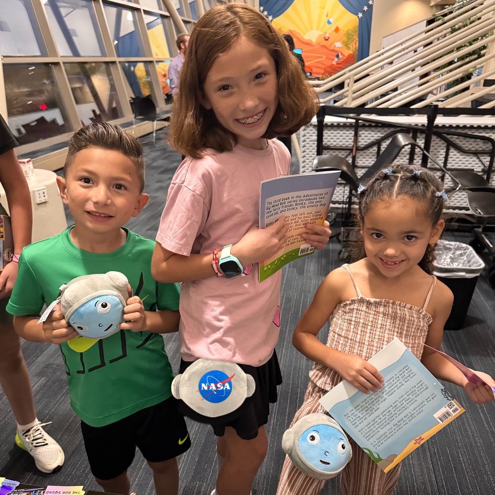 Kids holding the Big Head Bob official NASA plushie clip